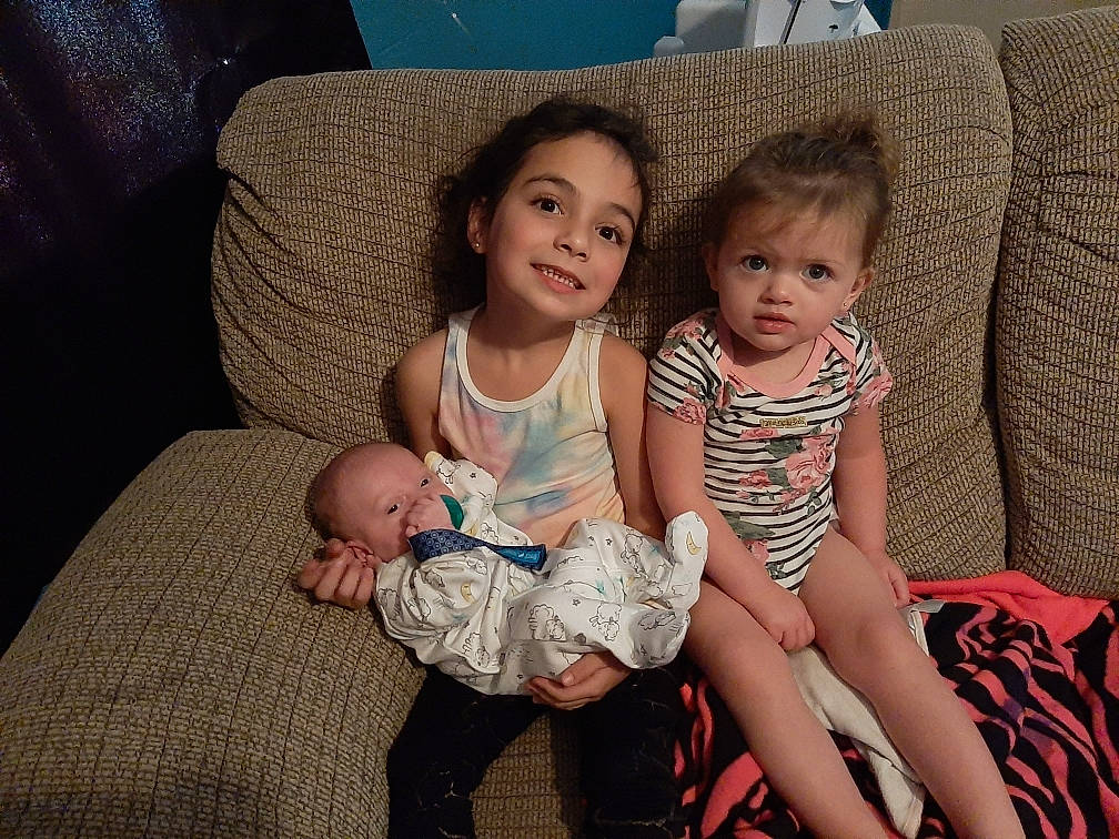 Sophie is registered to the contest to win money with this photo: baby, child, couch, cousin, eye, family, fun, iris, joy, lap, leg, people, person, sibling, sitting, skin, smile, toddler