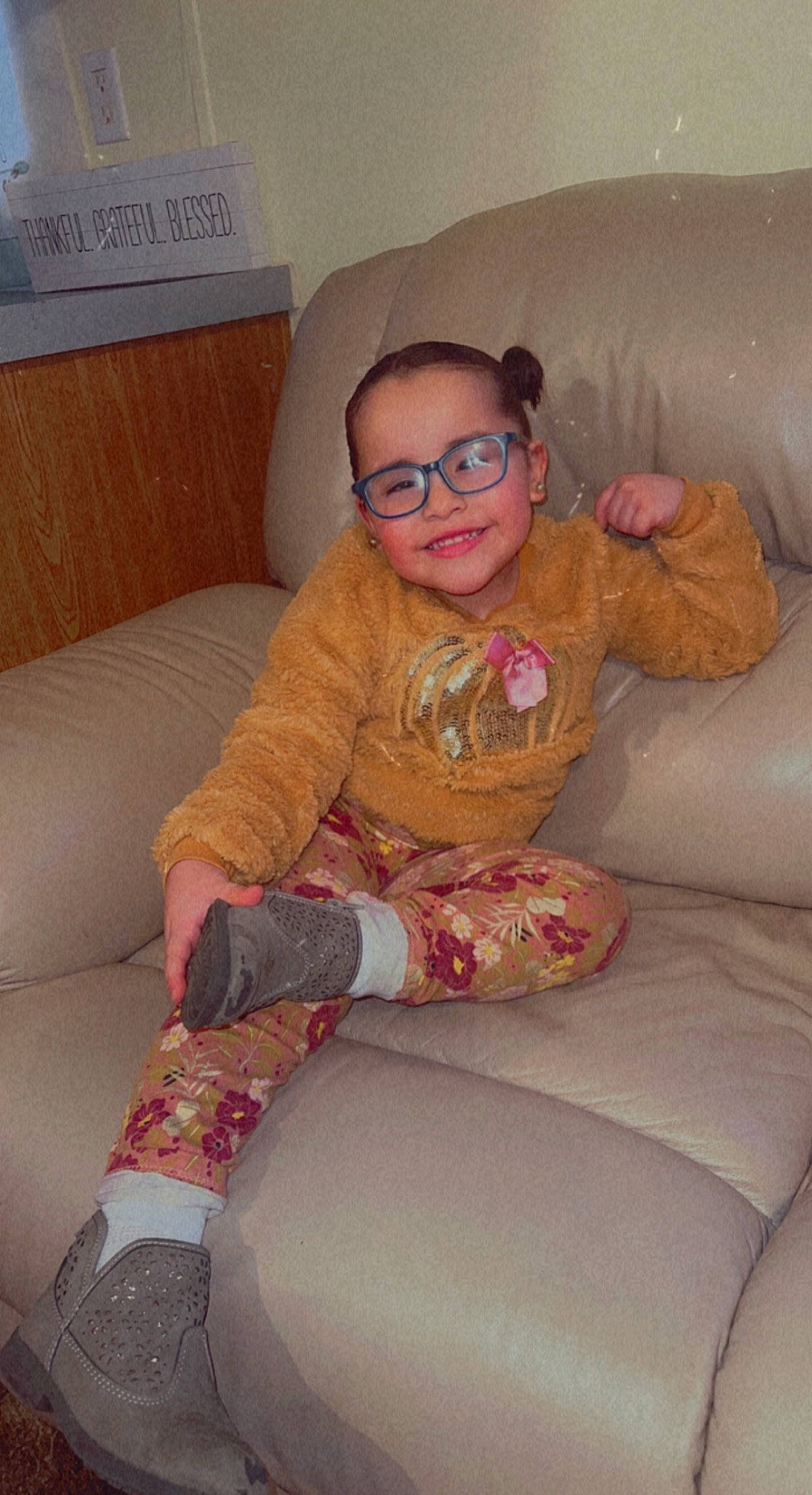 Maia joined the competition — help win amazing prizes! arm, blond, comfort, couch, eyewear, finger, glasses, happy, human_body, joy, knee, lap, living_room, neck, person, sitting, sleeve, smile, textile, thigh
