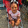 Alaia Noell is registered to the contest to win money with this photo: toddler, child, stroller, smile, outdoor, sunlight, pigtails, bows, rainbow_pattern, shoes, socks, concrete, steps, leaves, happy, person, clothing, cute, daylight, playful