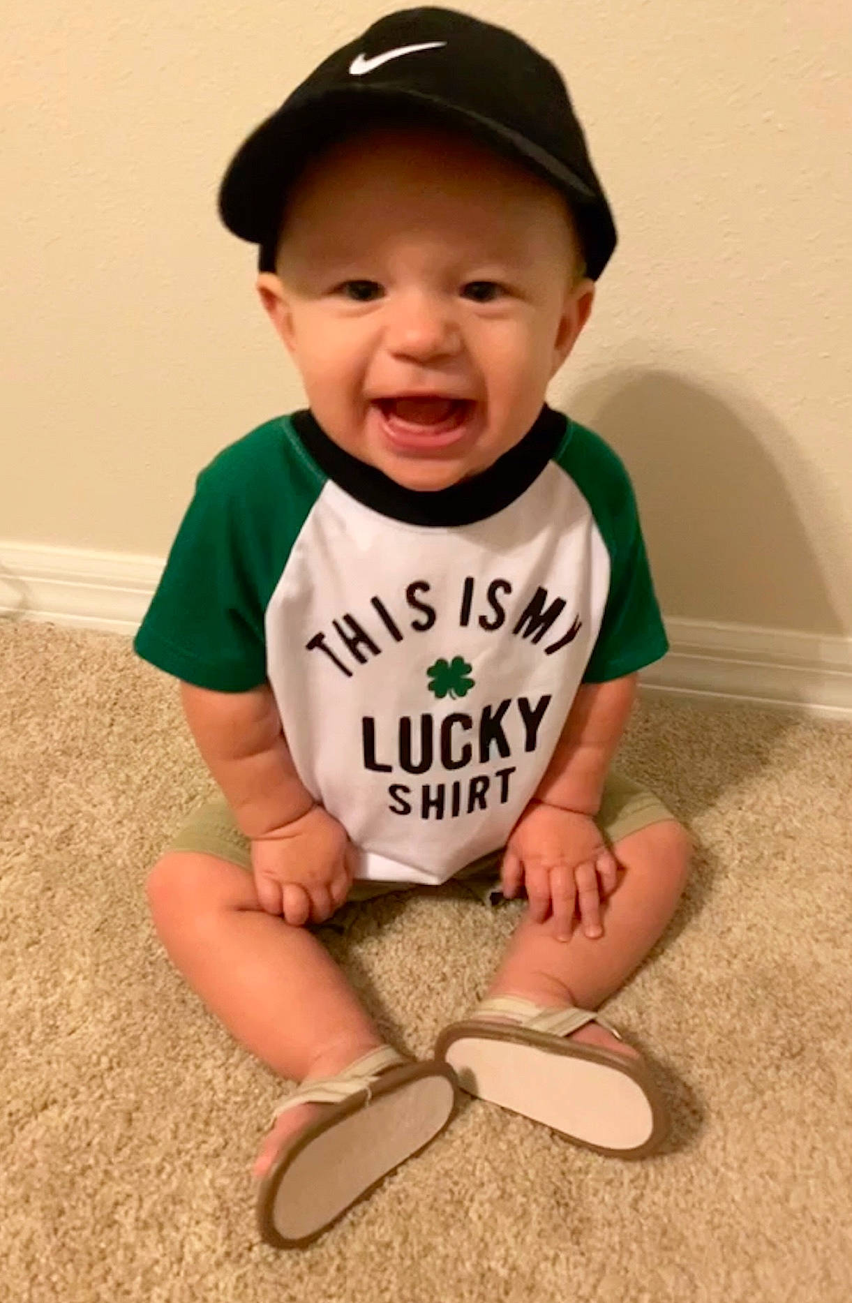 Harrison is registered to the contest to win money with this photo: baby, baby_toddler_clothing, baseball_cap, cap, cheek, chin, cool, eye, face, happy, hat, head, headgear, headwear, knee, person, skin, sleeve, smile, t_shirt