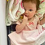 baby, infant, blanket, pacifier, crib, pink_clothing, bow, cute, child, sleepwear, soft_texture, resting, indoor, portrait, newborn, person, sleep, comfort, toddler, gaze