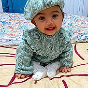 Aaira Ghosh is registered to the contest to win money with this photo: baby, bed, beret, blanket, child, cozy, cute, fabric, hands, happy, home, indoor, infant, knitted_clothing, patterned, person, portrait, sitting, smiling, warm_clothes