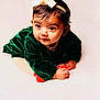 baby, infant, child, portrait, headband, green_dress, velvet, cute, curious, soft_lighting, studio, white_background, hands, face, looking_away, young, adorable, crawling, clothing, expression