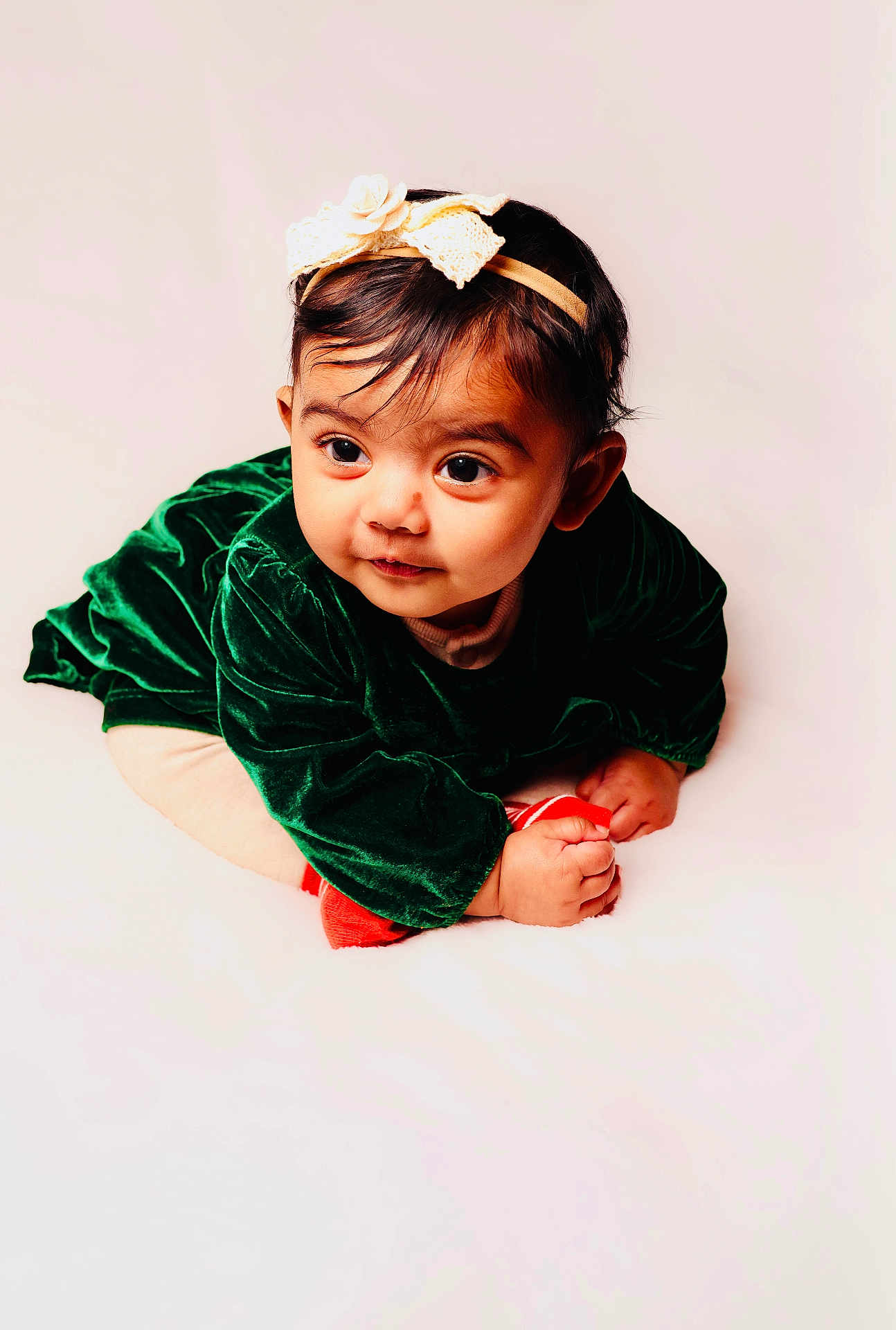 Aaira Ghosh joined the competition — help win amazing prizes! baby, infant, child, portrait, headband, green_dress, velvet, cute, curious, soft_lighting, studio, white_background, hands, face, looking_away, young, adorable, crawling, clothing, expression