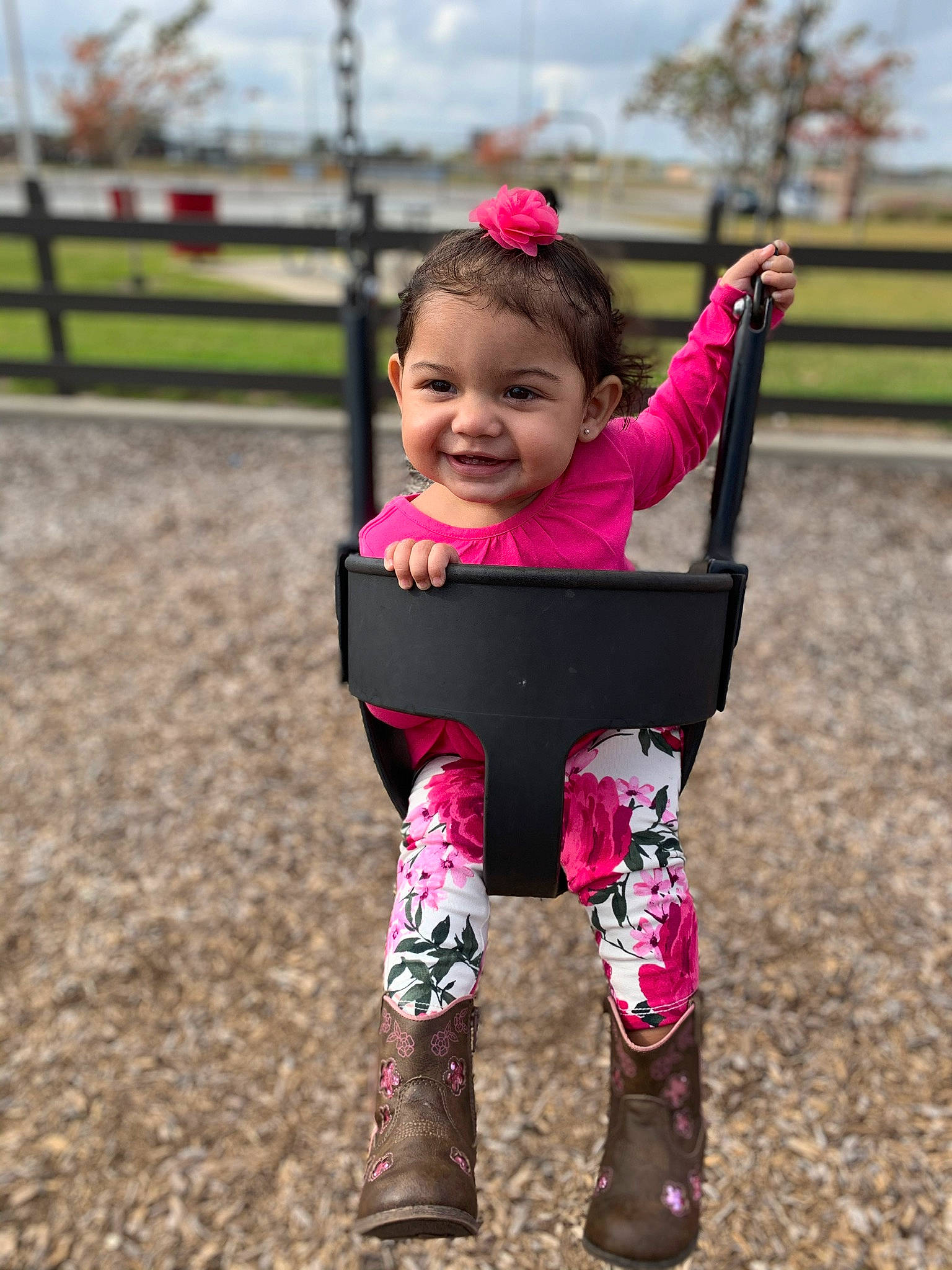 Anyah is registered to the contest to win money with this photo: child, face, fun, happy, head, human_settlement, joy, outdoor_play_equipment, people, person, pink, plant, play, playground, public_space, recreation, smile, spring, swing, toddler