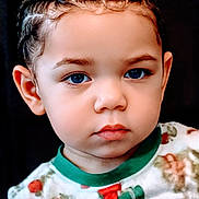 Koa is registered to the contest to win money with this photo: toddler, child, portrait, face, blue_eyes, braids, serious, clothing, patterned_shirt, close_up, indoor, young_child, baby, cute, expression, head_and_shoulders, person, fashion, hair, studio_lighting