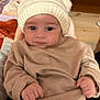 baby, child, infant, hat, knitted_hat, pom_poms, beige_sweater, clothing, indoor, person, cute, face, hands, warm, cozy, looking, portrait, young, soft, casual