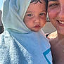 adult, blue, care, child, closeup, daylight, expression, face, happy, outdoor, person, portrait, skin, smile, sunlight, texture, toddler, towel, warmth, wrapped