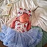 baby, infant, newborn, headband, bow, blue_tutu, dress, baby_wipes, bed, blanket, soft, cute, clothing, foot, hand, person, indoors, resting, sleepy, portrait