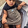 Isabella joined the competition — help win amazing prizes! toddler, child, stroller, dress, nike, black_hair_accessory, leopard_print, sandals, sidewalk, urban, outdoor, person, footwear, clothing, expression, hair, sitting, cute, fashion, baby