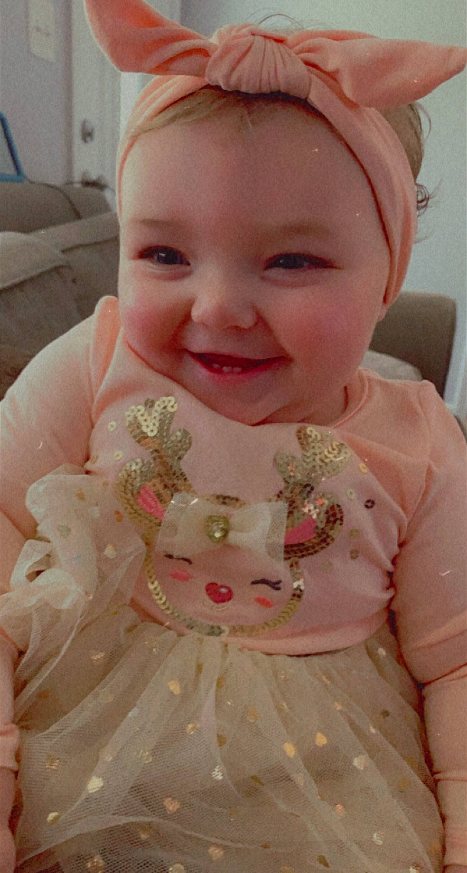 Camryn is registered to the contest to win money with this photo: baby, baby_laughing, baby_products, baby_toddler_clothing, cheek, child, day_dress, dress, embellishment, facial_expression, hair_accessory, headband, joy, lip, mouth, pattern, peach, person, pink, ruffle