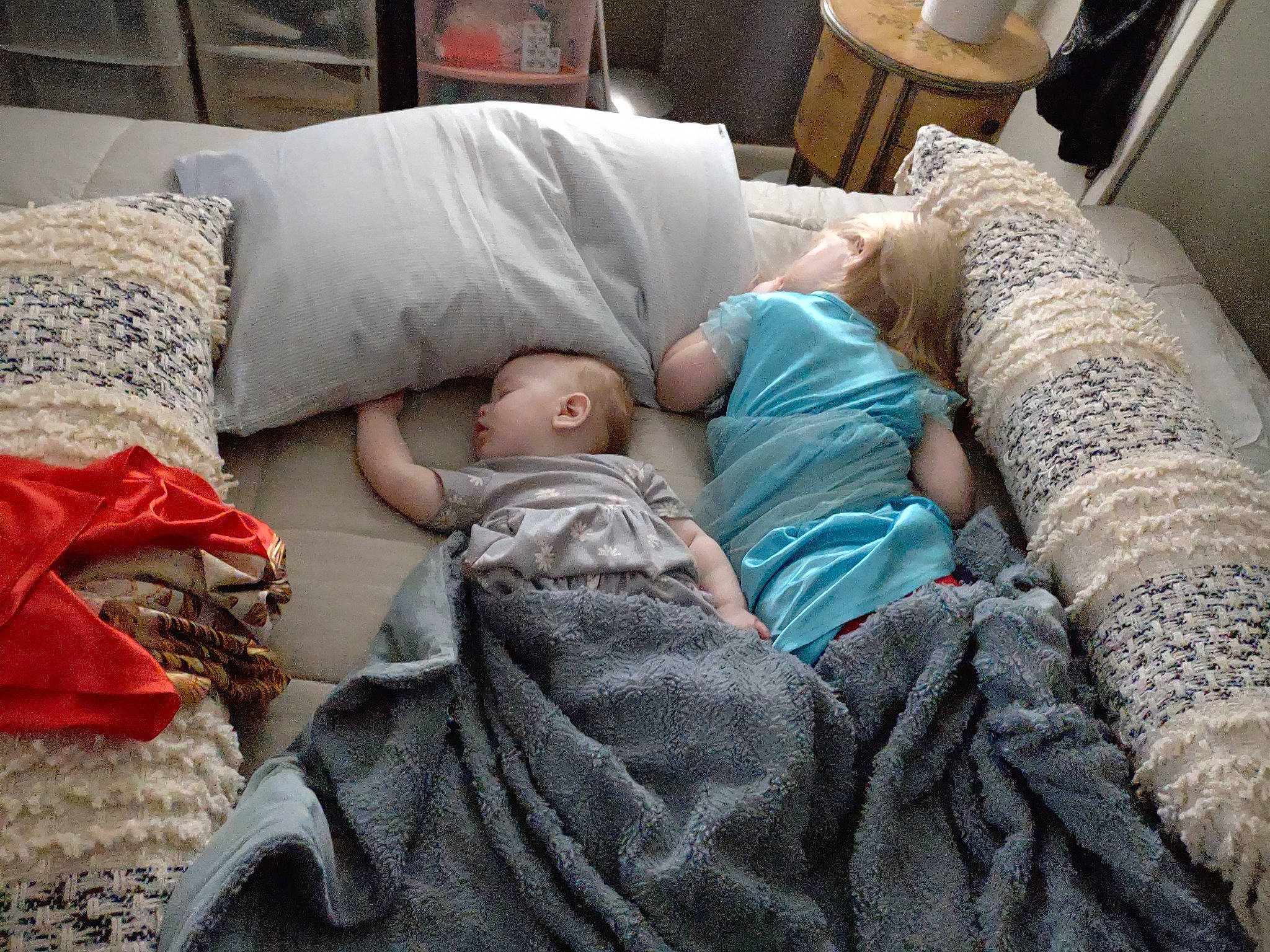 Katherine is registered to the contest to win money with this photo: baby, bed_sheet, bedding, bedtime, child, comfort, couch, flooring, leg, leisure, linens, living_room, nap, pattern, person, room, sitting, sleep, t_shirt, throw_pillow