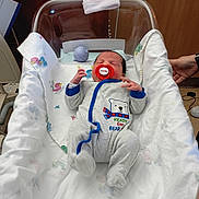 Savanna Buchanan is registered to the contest to win money with this photo: newborn, baby, pacifier, hospital, bassinet, blanket, clothing, onesie, bear, hand, person, infant, sleeping, bed, furniture, soft, cute, indoor, healthcare, cozy