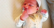 Savanna Buchanan is registered to the contest to win money with this photo: newborn, baby, infant, pacifier, onesie, hat, sleeping, lying_down, bed, mattress, cozy, cute, fist, small, child, adorable, peaceful, indoors, soft, resting