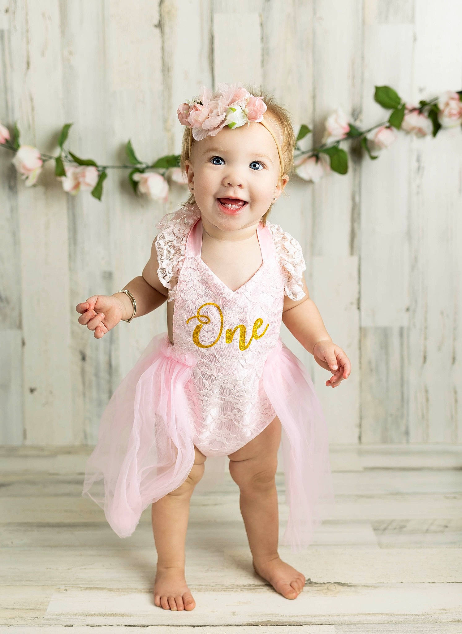 Riley joined the competition — help win amazing prizes! baby, baby_toddler_clothing, barefoot, child, clothing, day_dress, dress, embellishment, face, fun, happy, headpiece, headwear, iris, joy, one_piece_garment, peach, person, pink, sleeve