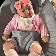 Marnie joined the competition — help win amazing prizes! apparel, baby, baby_seat, child, comfort, cozy, cushion, cute, expression, fabric, face, hands, headband, indoors, infant, knit_sweater, legs, pink_bow, portrait, sock