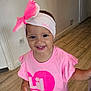 toddler, child, smiling, headband, pink_clothing, indoor, wooden_floor, happy, person, cute, baby, short_sleeves, girl, portrait, young_child, fashion, accessory, casual_wear, standing, bright_colors