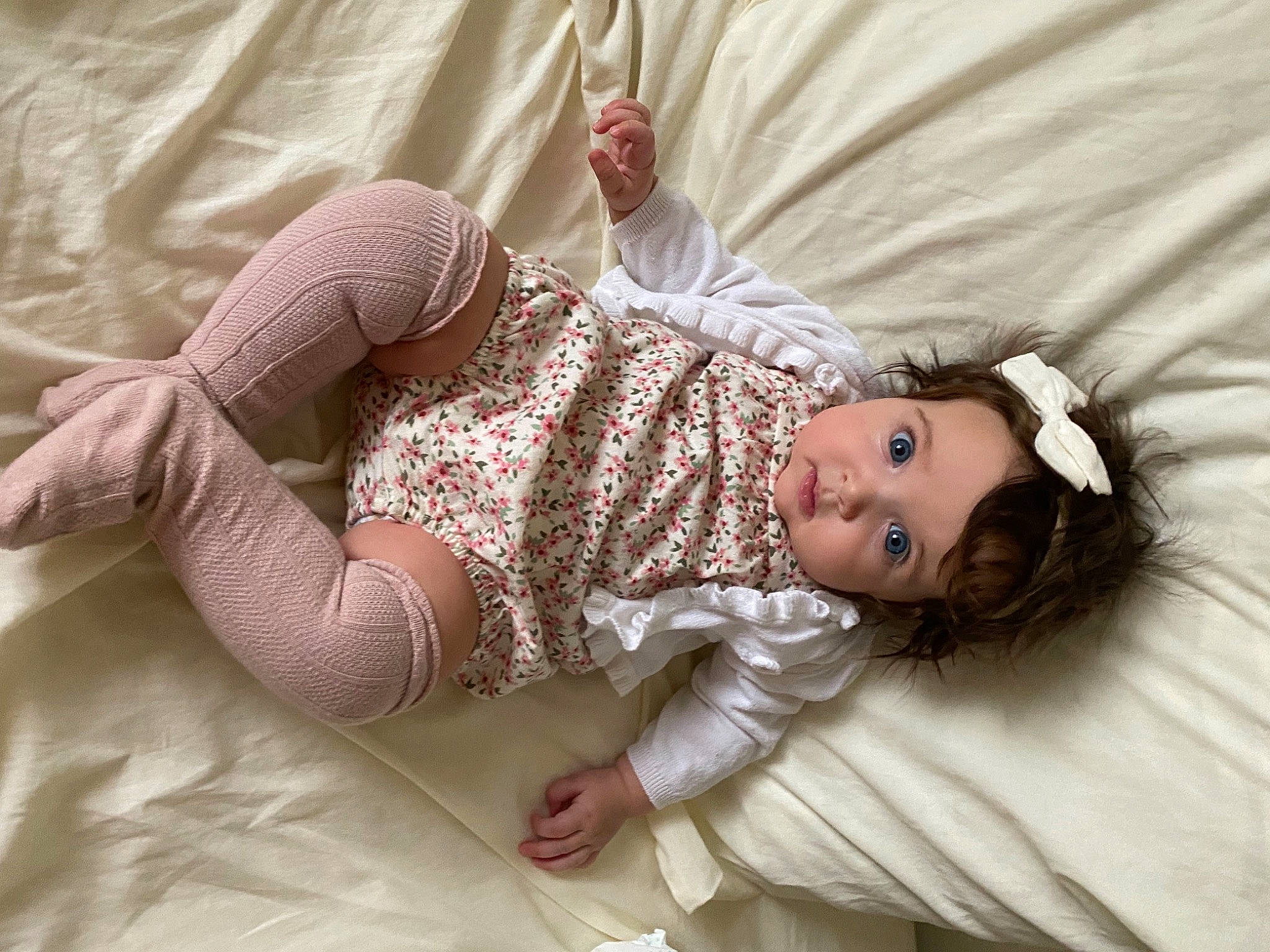 Hallie is registered to the contest to win money with this photo: baby, baby_toddler_clothing, comfort, dress, eye, eyelash, finger, happy, head, headgear, human_body, linens, lip, neck, person, pink, shoulder, skin, sleeve, textile