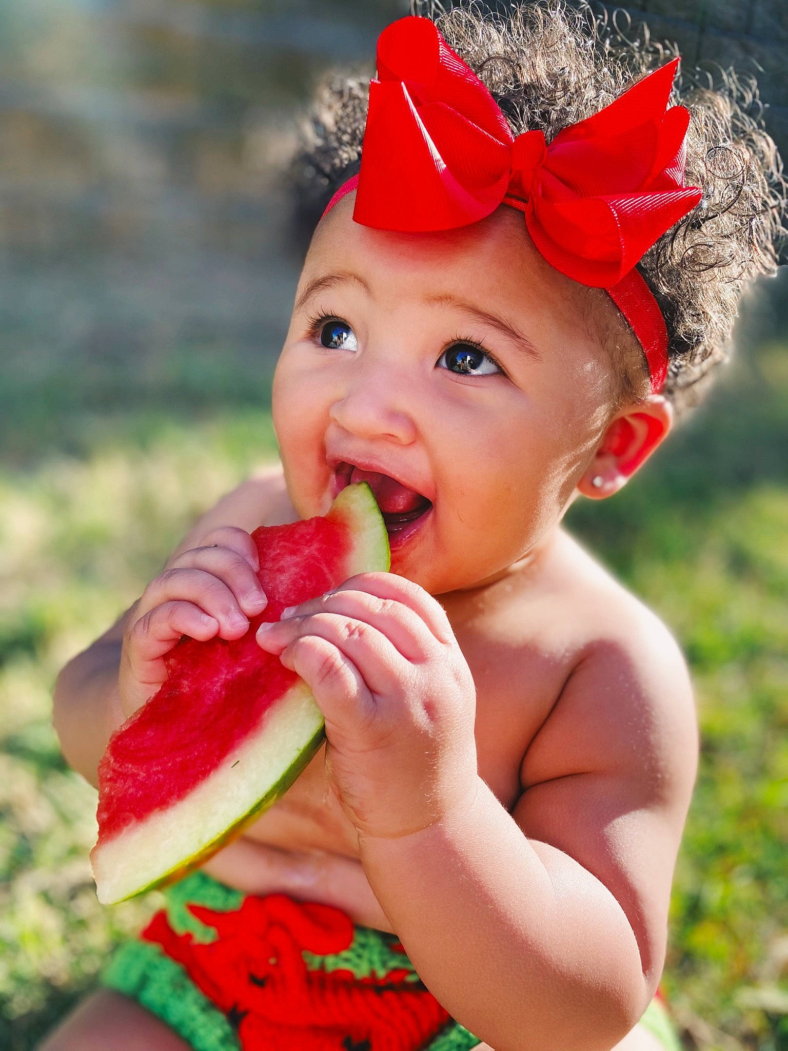 Kamiyah is registered to the contest to win money with this photo: baby, biting, child, child_model, citrullus, eating, food, fruit, happy, hat, headgear, headwear, melon, mouth, nose, person, plant, skin, smile, sweetness