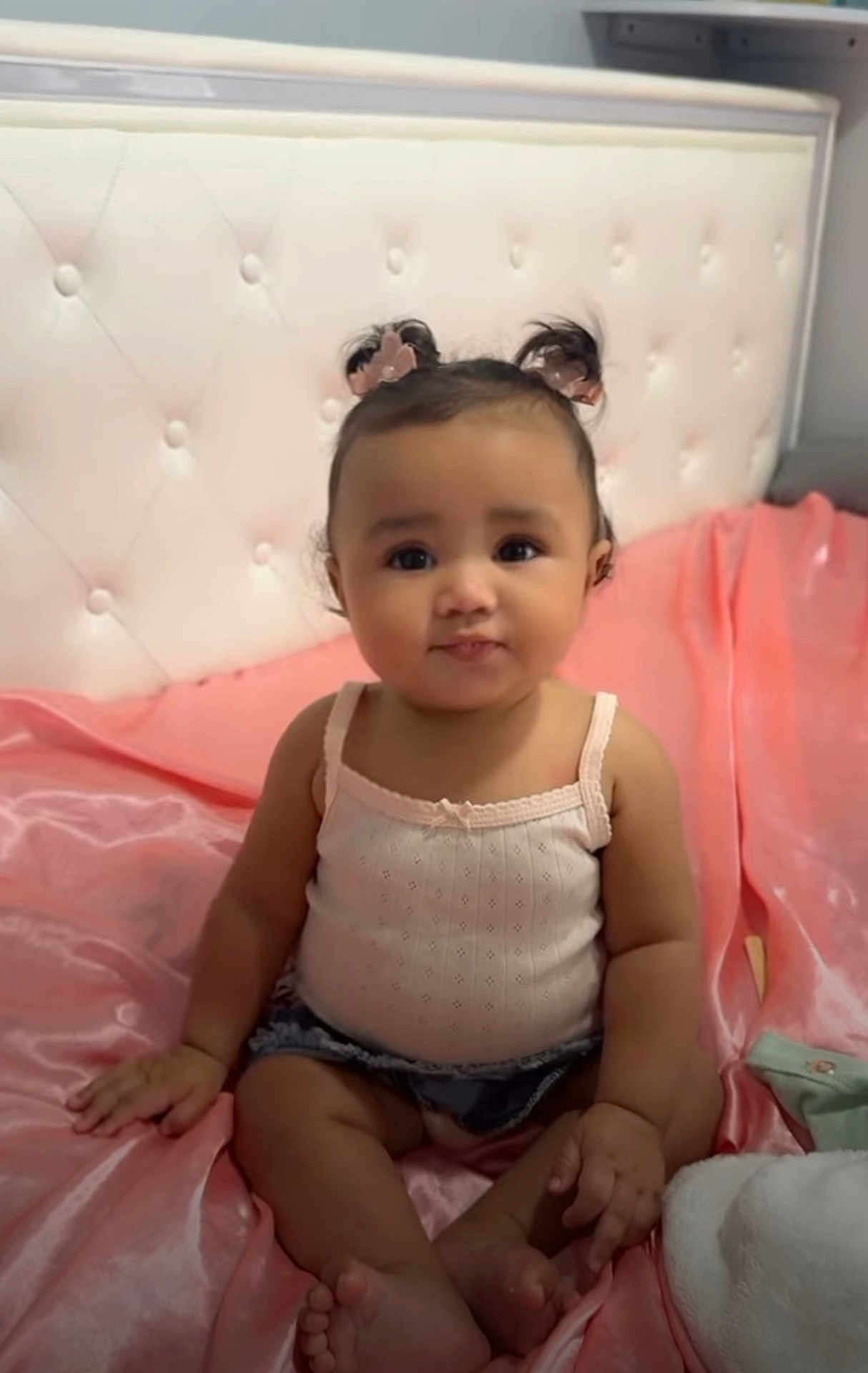 Malaya joined the competition — help win amazing prizes! baby, child, girl, pigtails, bed, pink, silk, top, denim, shorts, cute, portrait, indoor, headboard, sitting, smile, skin, hand, foot, furniture