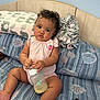 Malaya joined the competition — help win amazing prizes! baby, child, infant, bottle, bed, pillow, blanket, onesie, curly_hair, tablet, pink, blue, elephant_print, shell_pattern, cushion, indoor, cute, sitting, holding, face