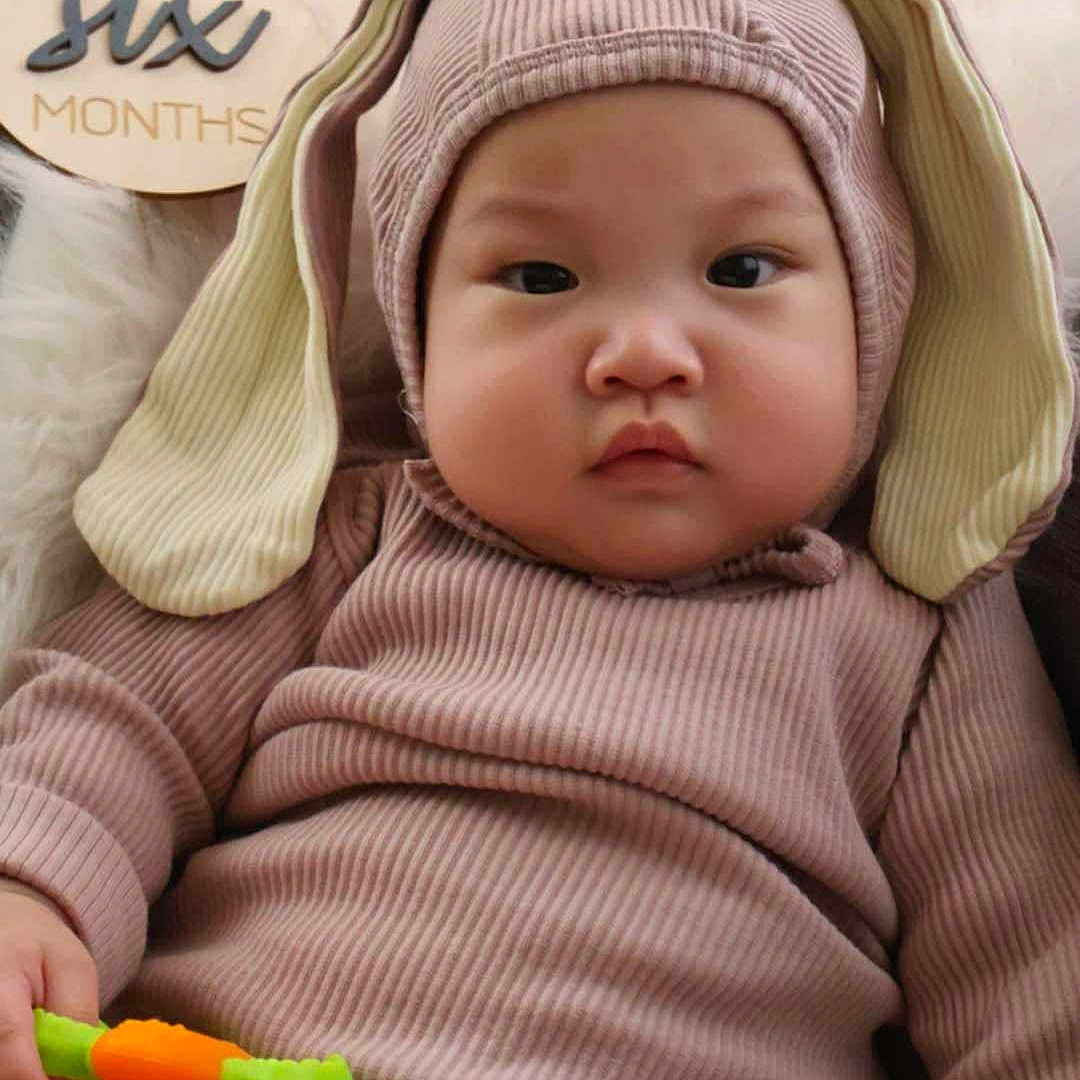 Kaiden Zayn joined the competition — help win amazing prizes! baby, beanie, blanket, bonnet, cap, clothing, couch, face, frown, furniture, hat, head, hood, knitwear, newborn, person, photography, portrait, sweater, toy
