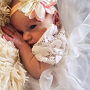 Phoenix is registered to the contest to win money with this photo: baby, infant, flower_headband, white_lace, tulle, blanket, soft_texture, sleeping, peaceful, cute, newborn, portrait, closeup, delicate, adorable, child, resting, feminine, soft_lighting, cozy