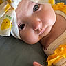 Sowene participe au concours pour gagner de l'argent avec cette photo : adorable, baby, cheeks, child, close_up, clothing, cute, expression, eyes, fabric, fist, headband, indoors, infant, lemon_pattern, lying_down, newborn, portrait, soft_skin, yellow