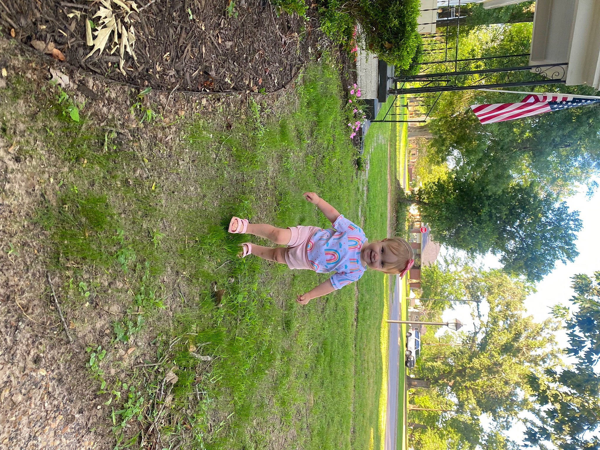 Reagan is registered to the contest to win money with this photo: adventure, flag, fun, grass, house, joy, landscape, leisure, people_in_nature, person, plant, pole, recreation, shrub, slope, soil, sport_climbing, tree, trunk, vegetation