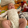 arm, baby, child, chubby, cute, fabric, face, fox_toy, happy, indoors, infant, legs, lying_down, onesie, pillow, play_mat, plush_toy, smiling, soft_toys, teddy_bear