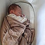 baby, newborn, sleeping, blanket, bassinet, cozy, infant, wrapped, peaceful, soft, cushion, child, cute, indoors, resting, portrait, person, fabric, bed, comfort