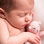 baby, newborn, sleeping, stuffed_toy, teddy_bear, cuddling, close_up, portrait, infant, skin, peaceful, hand, arm, eyelashes, nose, head, blanket, knit, pink, soft_texture