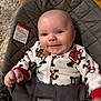 Jameson is registered to the contest to win money with this photo: baby, infant, smiling, pajamas, holiday_theme, bouncer, babybjorn, indoor, face, child, cute, happy, person, seated, clothing, wood_floor, carpet, closeup, portrait, comfort
