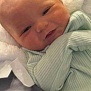 Jameson is registered to the contest to win money with this photo: baby, infant, face, smile, clothing, blanket, closeup, newborn, cozy, soft_texture, child, portrait, cute, happy, wrapped, young, skin, head, eyes, expression