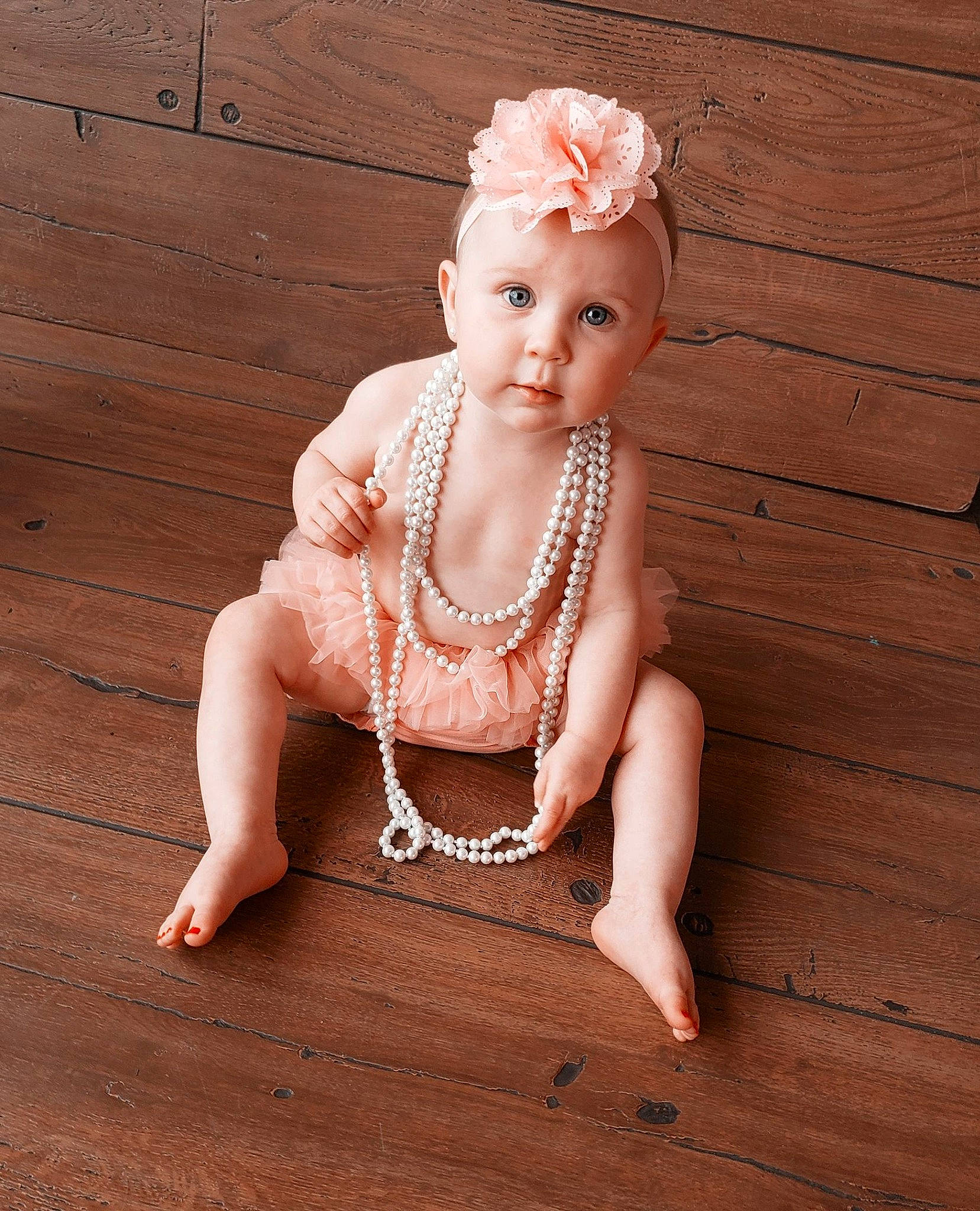 Aliza is registered to the contest to win money with this photo: arm, baby_toddler_clothing, eye, flash_photography, floor, flooring, hair, happy, hardwood, head, headpiece, headwear, human_body, jewellery, leg, neck, necklace, person, sleeve, toddler