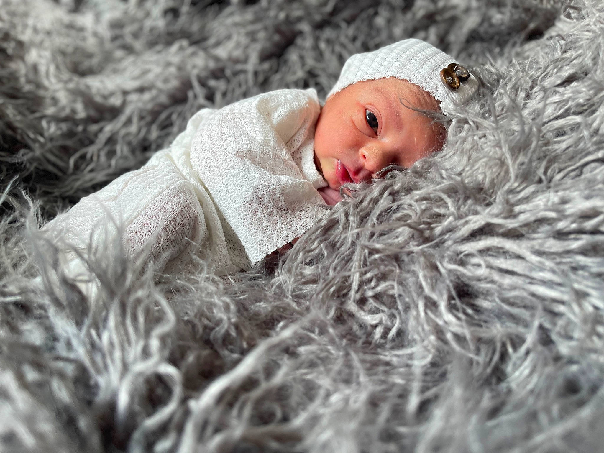 Ariyah joined the competition — help win amazing prizes! baby, beanie, cap, child, doll, freezing, frost, fur, grass, happy, hat, headgear, knit_cap, linens, pattern, people_in_nature, person, plant, toddler, wood