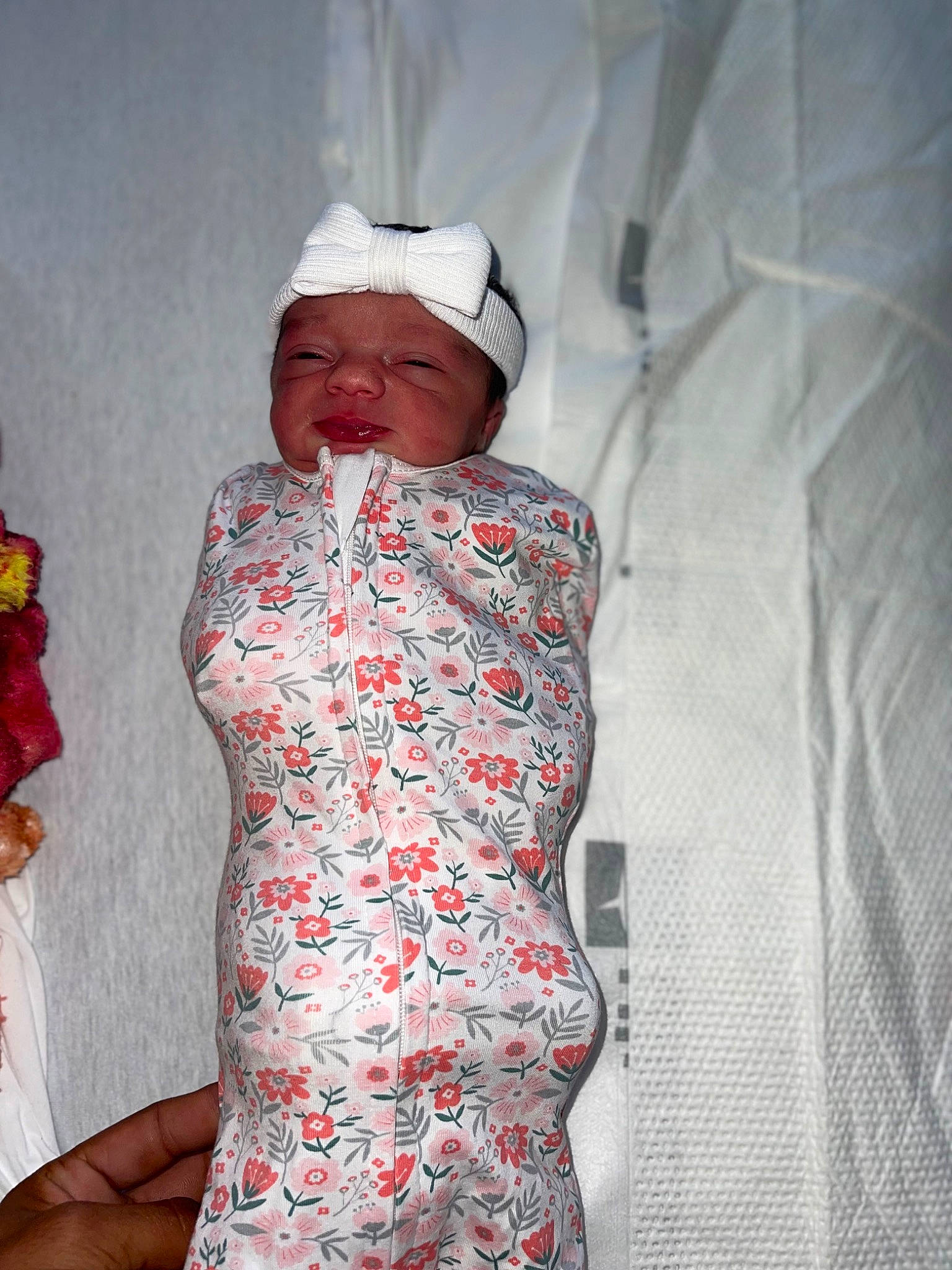 Ariyah joined the competition — help win amazing prizes! baby, baby_toddler_clothing, cap, carmine, child, comfort, dress, event, facial_expression, fashion_design, gesture, hat, headwear, linens, pattern, peach, person, room, skin, sleeve