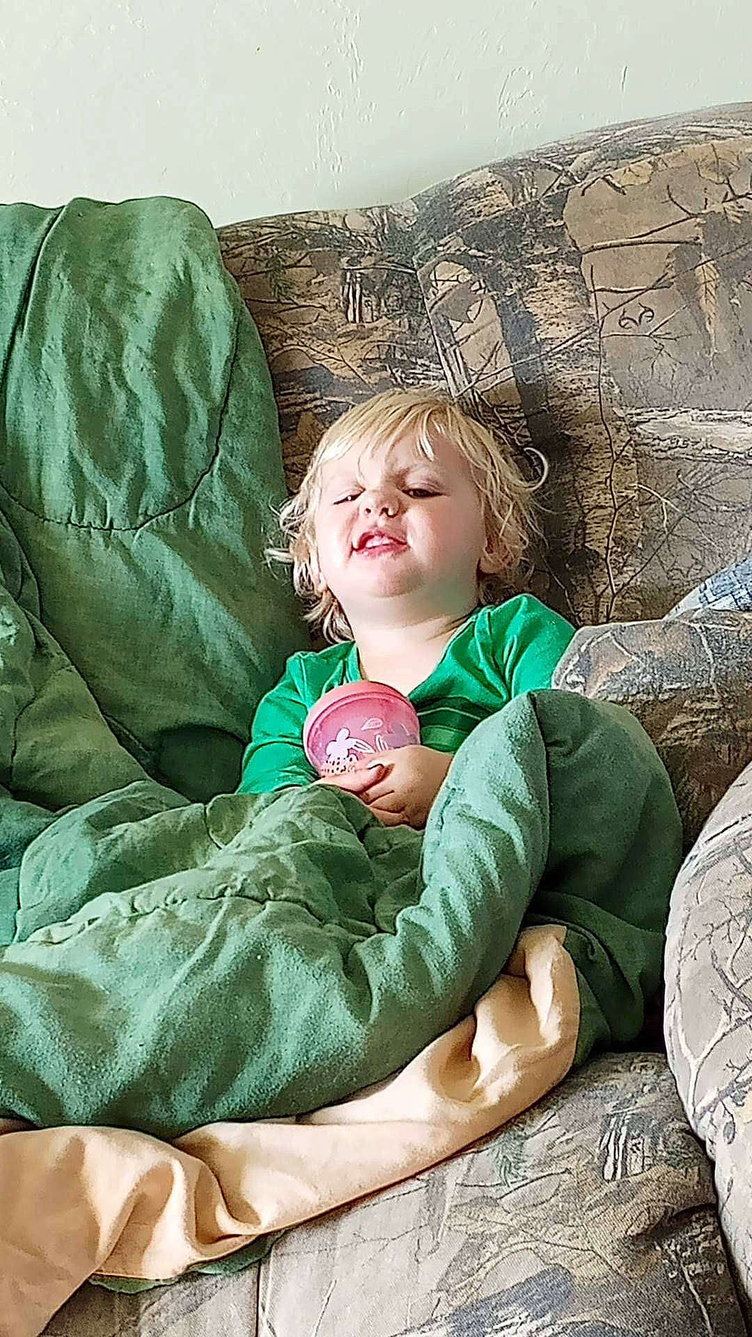 Jordyn is registered to the contest to win money with this photo: child, comfort, couch, eye, face, fun, grass, happy, head, leisure, linens, person, plant, portrait_photography, room, sitting, throw_pillow, toddler, tree