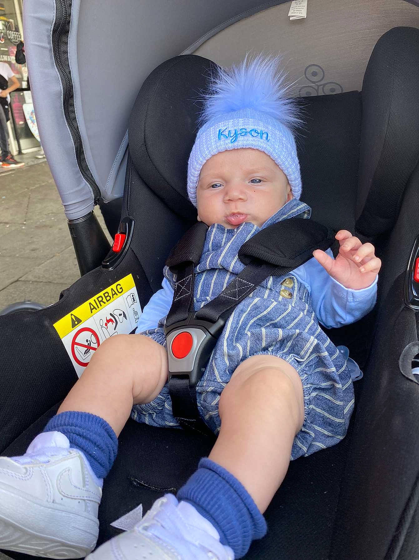 Kyson is registered to the contest to win money with this photo: auto_part, baby, baby_carriage, baby_in_car_seat, baby_products, baby_toddler_clothing, car_seat, car_seat_cover, child, comfort, electric_blue, headwear, human, lap, leg, person, product, sitting, steering_wheel, thigh