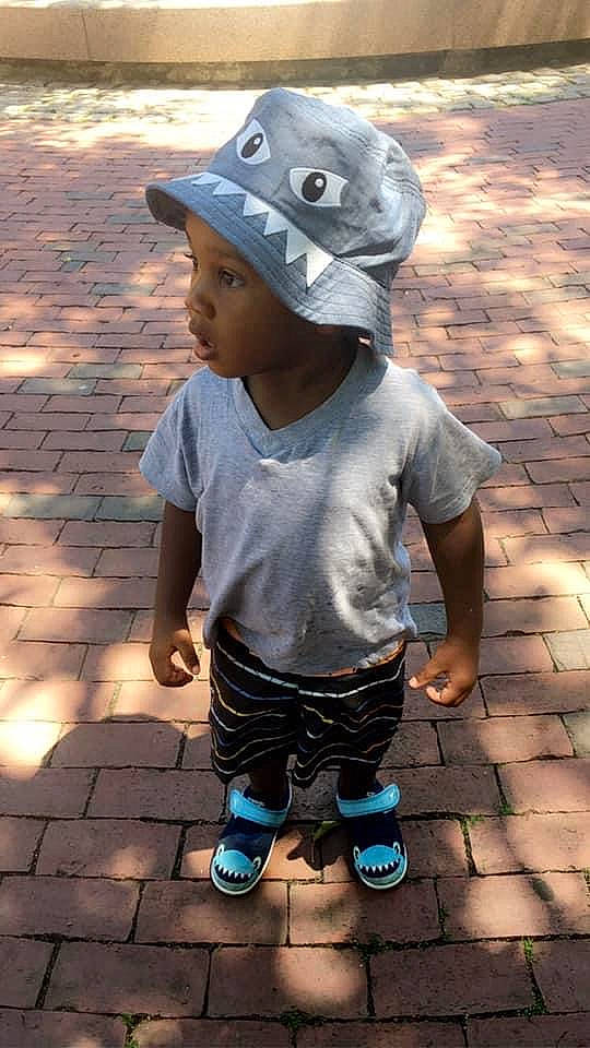 Audri is registered to the contest to win money with this photo: active_pants, baby_toddler_clothing, child, clothing, cobblestone, cool, hat, headwear, pattern, person, sandal, shadow, shoe, shorts, sock, sun_hat, sweatpant, t_shirt, toddler, walking_shoe
