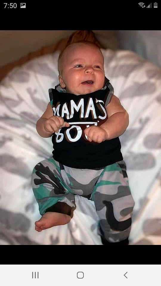 Kayne is registered to the contest to win money with this photo: baby, baby_products, baby_toddler_clothing, child, comfort, eye, flash_photography, happy, human_leg, linens, monochrome_photography, pattern, person, sitting, sleeve, smile, sock, t_shirt, textile, thigh