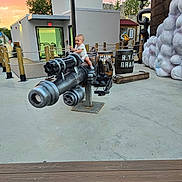 Luka is registered to the contest to win money with this photo: artillery, baby, camera, cannon, clothing, electronics, flagstone, footwear, machine, motor, pants, path, person, plywood, shoe, tire, walkway, weapon, wood, worker