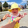 baby, child, infant, smiling, happy, sunhat, yellow_clothing, swimsuit, outdoor, pool, swimming_pool, water, summer, sunny, family, adult_hands, portrait, playful, residential_background, blue_sky
