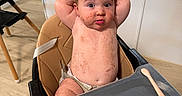 Jensen joined the competition — help win amazing prizes! baby, infant, child, high_chair, kitchen, indoor, sitting, portrait, face, eyes, hair, smile, messy, food, food_stains, fruit, pacifier, spoon, baby_gear, home