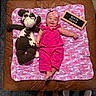 Jensen joined the competition — help win amazing prizes! baby, infant, child, smiling, pink_outfit, headband, bow, plush_toy, cow_toy, blanket, crocheted_blanket, letter_board, month_seven, milestone, portrait, indoor, top_down, couch, brown_leather, carpet
