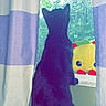 cat, black_cat, animal, pet, sitting, window, windowsill, curtains, indoor, home, backlit, silhouette, outdoors, trees, nature, plush_toy, yellow_toy, red_details, watching, portrait