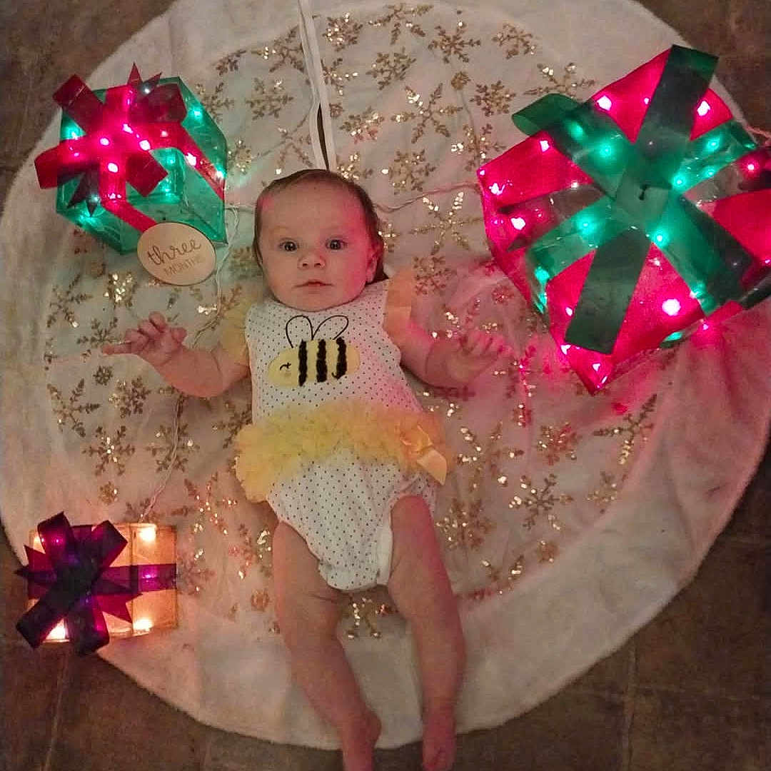 Alexandria is registered to the contest to win money with this photo: baby, bed, clothing, costume, couch, cushion, diaper, dress, face, furniture, hat, head, homedecor, lighting, newborn, person, photography, portrait, purple, sitting