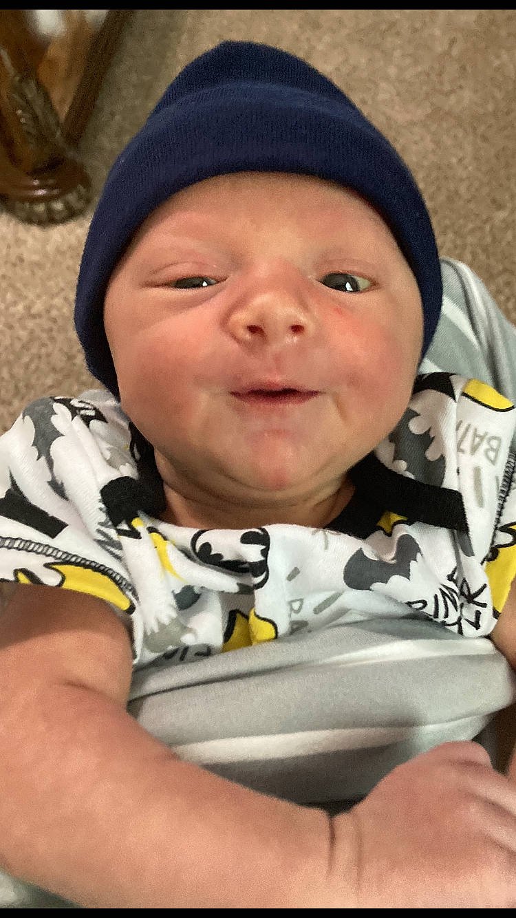 Dasean is registered to the contest to win money with this photo: baby, baby_toddler_clothing, cheek, child, chin, clothing, comfort, cool, eye, fun, grass, happy, headgear, headwear, jacket, nose, person, product, skin, sleeve