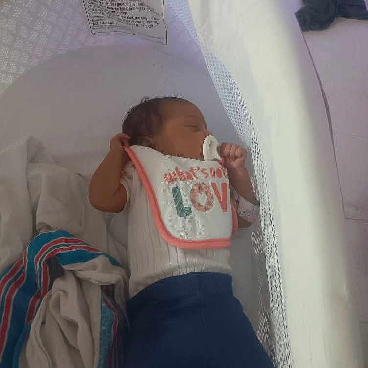 Jalae is registered to the contest to win money with this photo: baby, bassinet, bed, bib, blanket, blue, child, clothing, comfort, cute, indoors, infant, newborn, pacifier, peaceful, resting, sleeping, soft, text, white