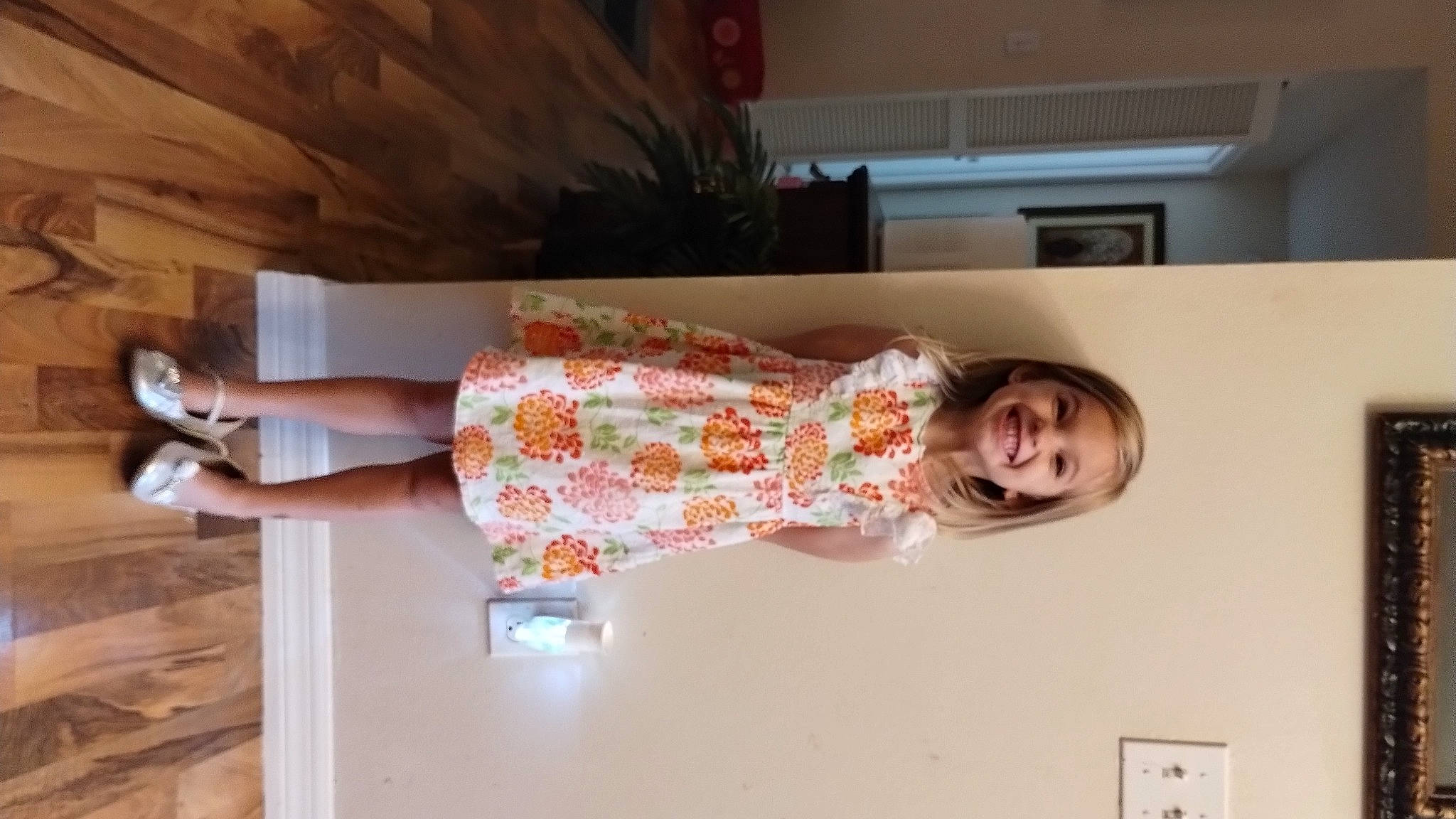 Kylie is registered to the contest to win money with this photo: child, flooring, foot, fun, hardwood, hat, human_leg, joy, knee, leg, light_switch, peach, person, room, sandal, sleeve, smile, thigh, toddler, wood